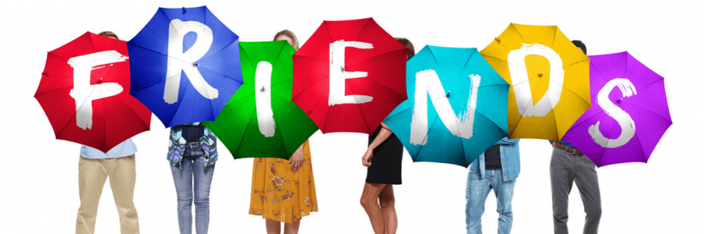 The cast of Friends - The Musical Parody stood behind colourful umbrellas which each have a letter on to spell out 'friends'.